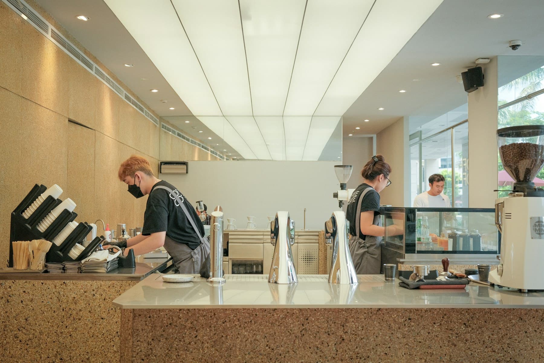 A café team serving customers and preparing coffee