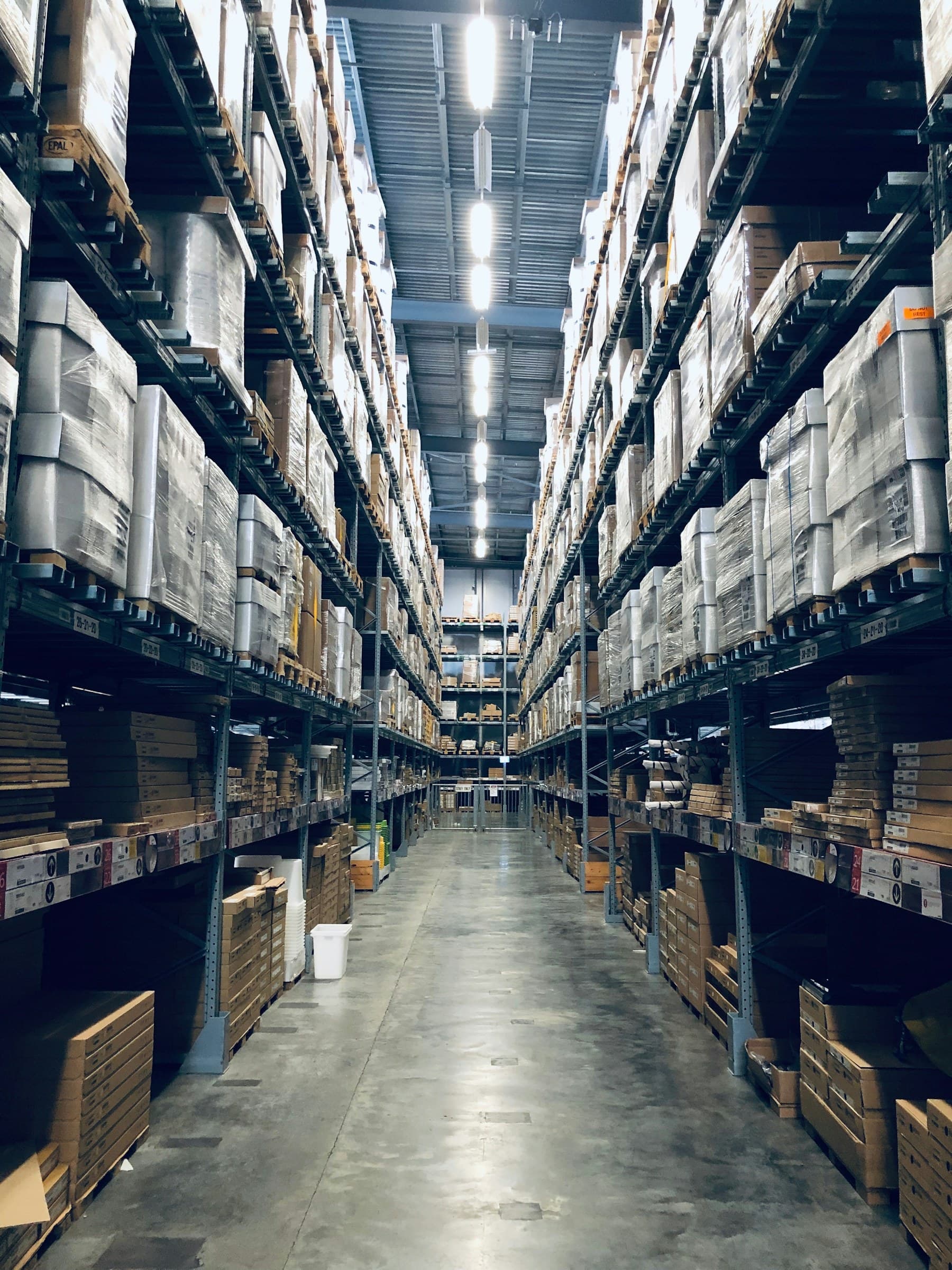 Inventory stored on shelves along a warehouse aisle